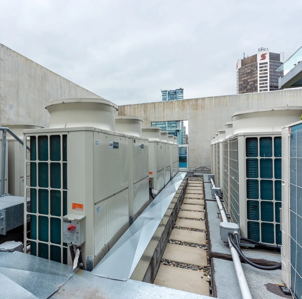 Mitsubishi City Multi VRF rooftop condensing units in rows on commercial building in Toronto
